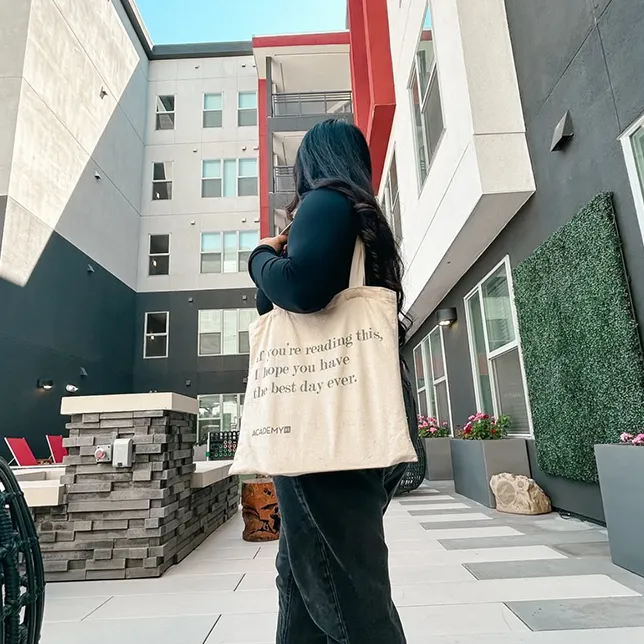 young woman holding a tote bag